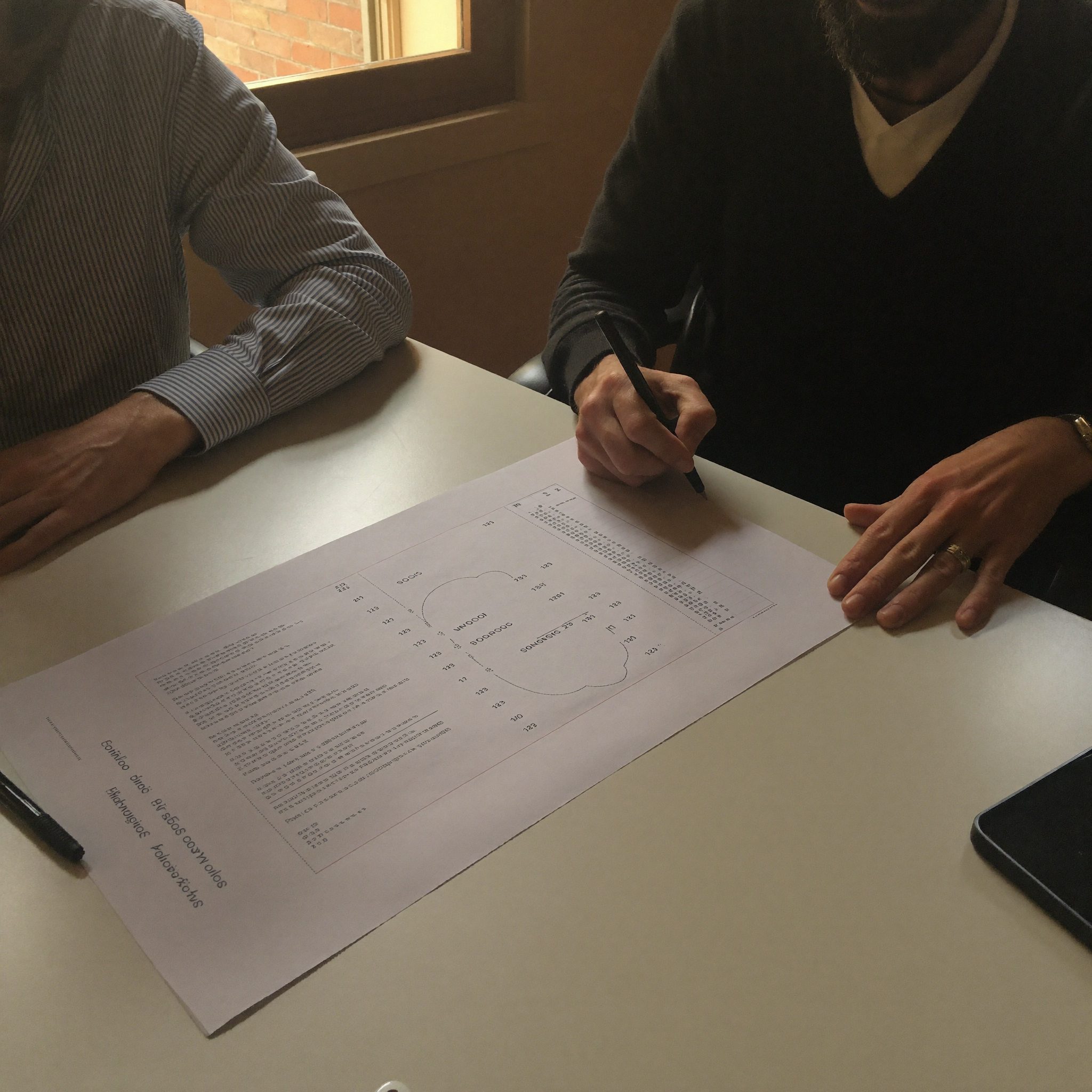 A planning session with a retirement projection shown on paper