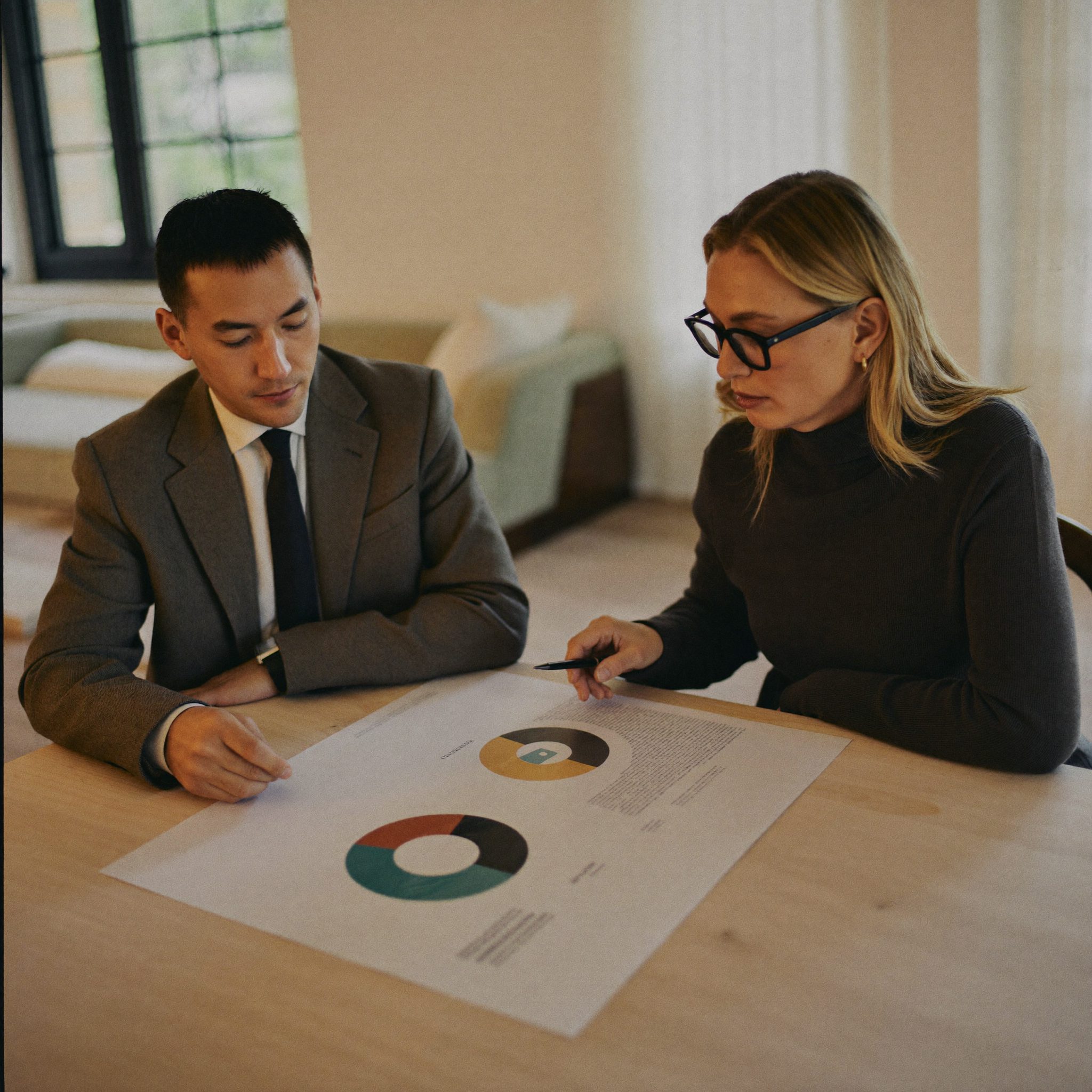 Senior consultant reviewing a retirement projection with a long-standing client